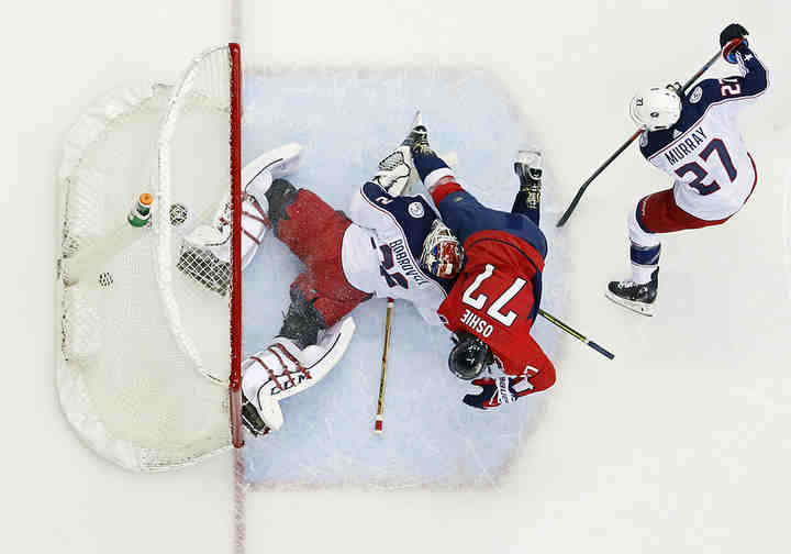 Washington Capitals right wing T.J. Oshie (77) scores a goal on Columbus Blue Jackets goaltender Sergei Bobrovsky (72) behind defenseman Ryan Murray (27) during the first period of Game 1 of the Stanley Cup Playoffs first-round series at Capital One Arena in Washington D.C.  (Adam Cairns / The Columbus Dispatch)